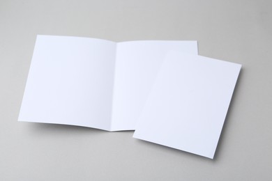 Photo of Blank greeting cards on light background, closeup