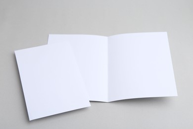 Photo of Blank greeting cards on light background, closeup