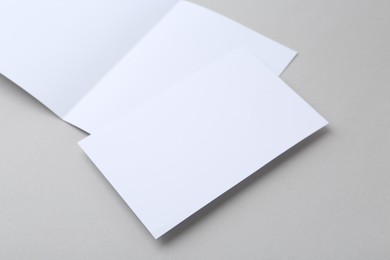 Photo of Blank greeting cards on light background, closeup