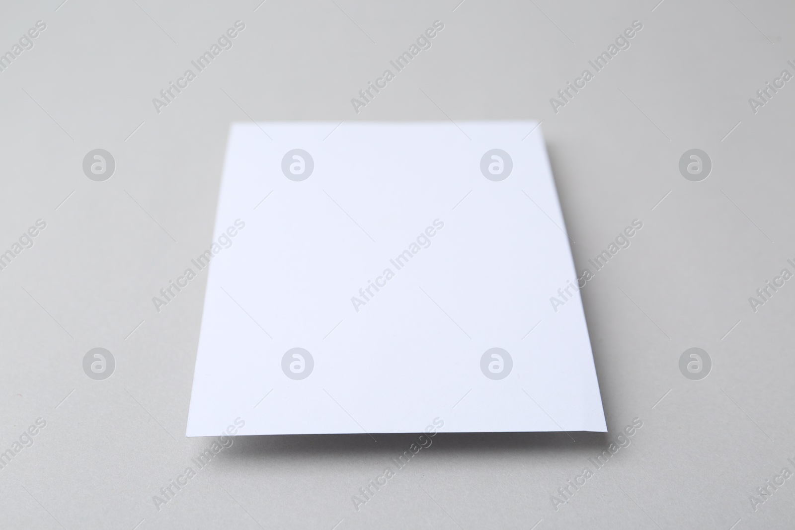 Blank greeting card on light background, closeup Photo of Blank greeting card on light background, closeup