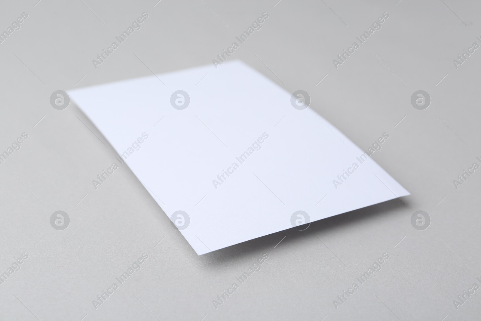 Photo of Blank greeting card on light background, closeup