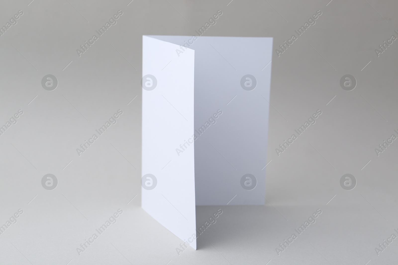 Photo of One blank greeting card on light background