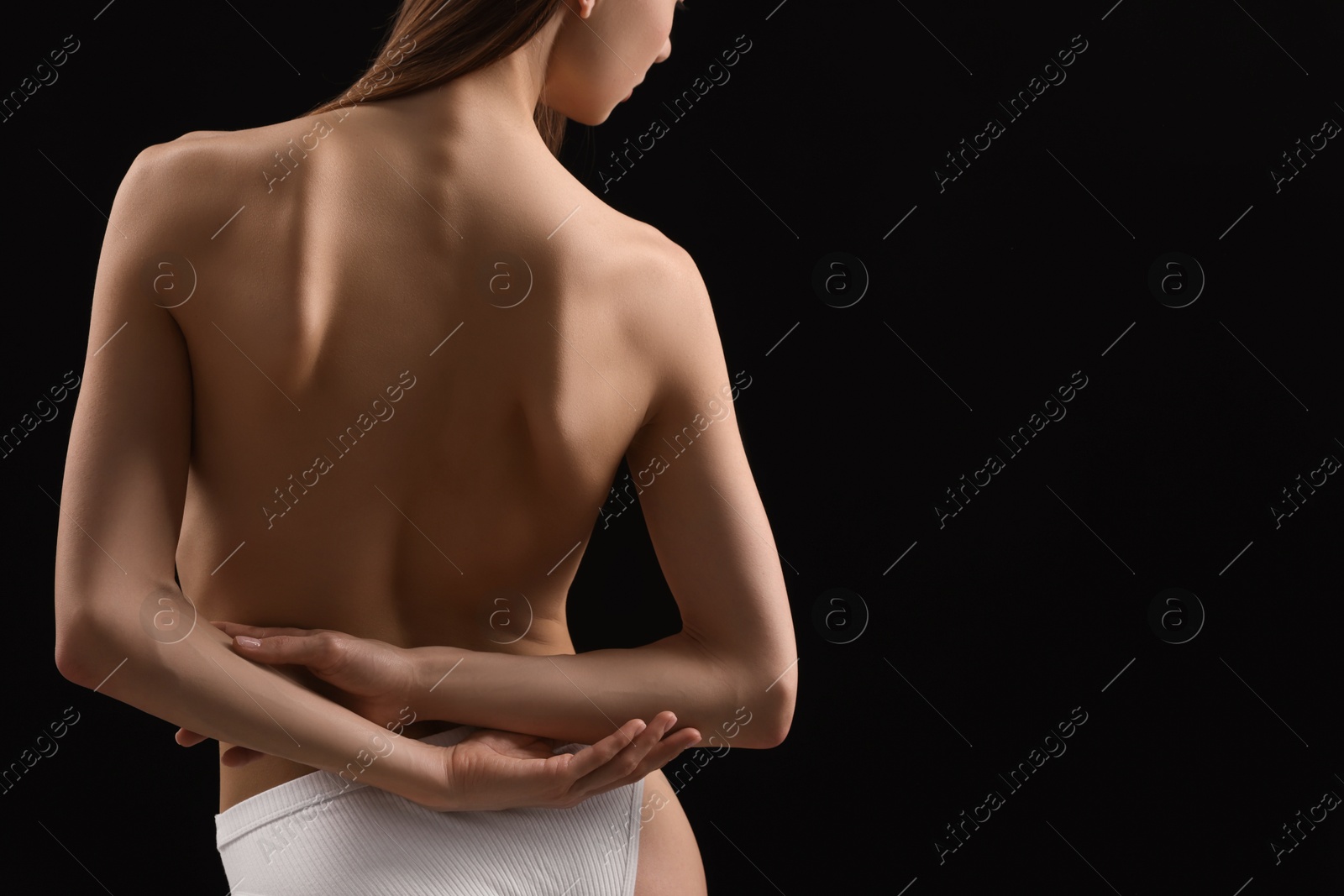 Nude woman on black background, closeup. Space for text Photo of Nude woman on black background, closeup. Space for text