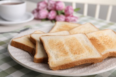 Photo of Tasty crispy toasted bread slices on table, closeup