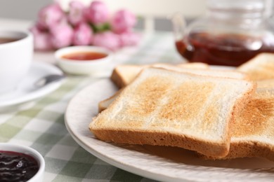 Photo of Tasty crispy toasted bread slices on table, closeup