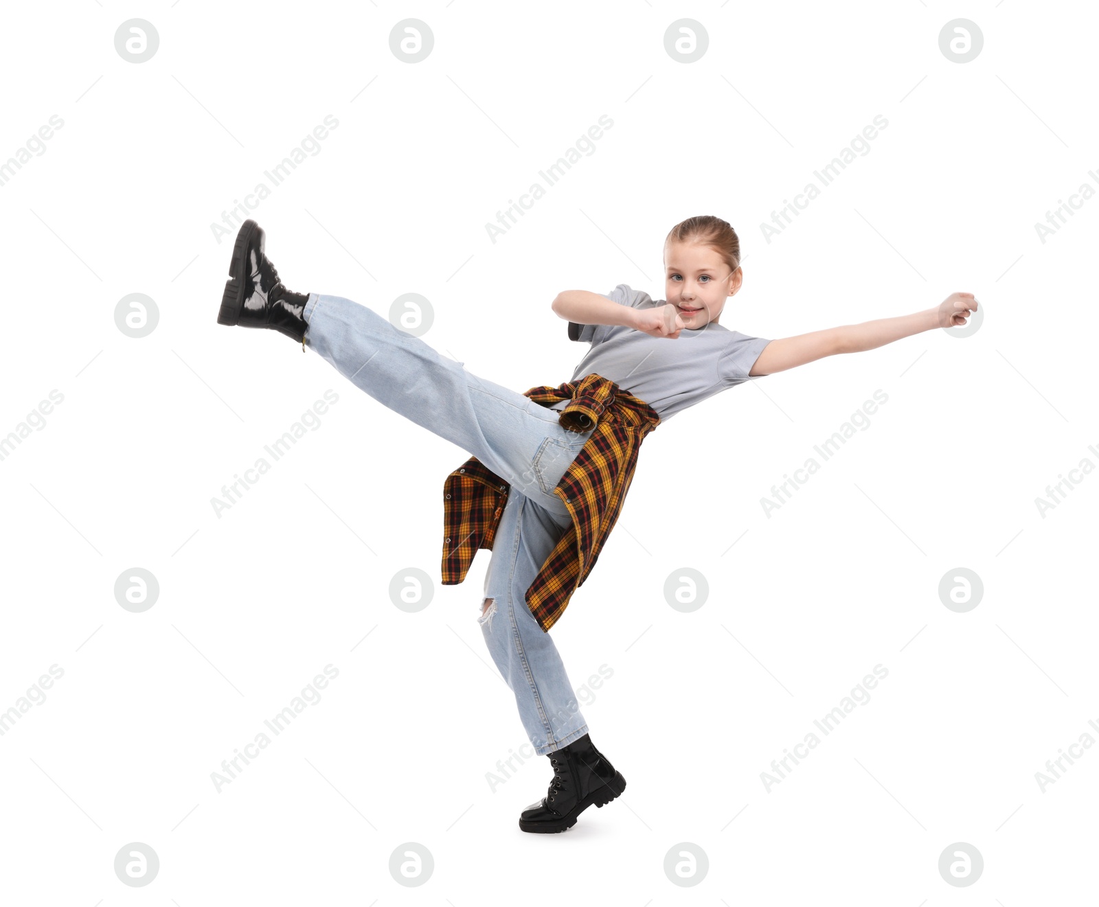 Girl in stylish clothes dancing on white background Photo of Girl in stylish clothes dancing on white background