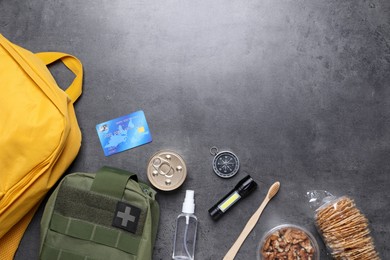 Photo of Survival kit. Different emergency supplies on grey table, flat lay. Space for text