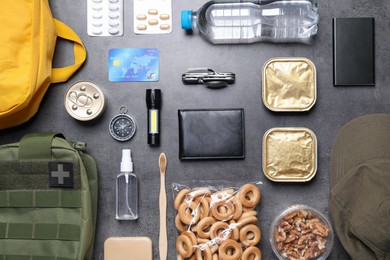 Photo of Survival kit. Different emergency supplies on grey table, flat lay
