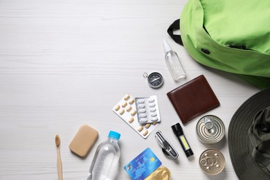 Photo of Survival kit. Different emergency supplies on white wooden table, flat lay. Space for text