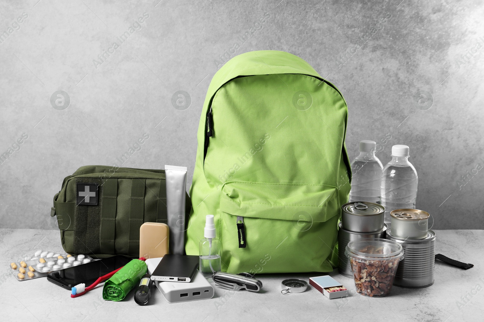 Survival kit. Different emergency supplies on light table Photo of Survival kit. Different emergency supplies on light table