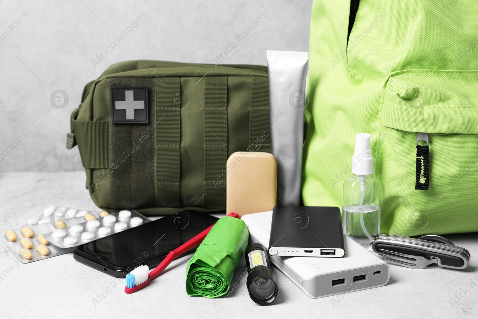 Survival kit. Different emergency supplies on light table Photo of Survival kit. Different emergency supplies on light table