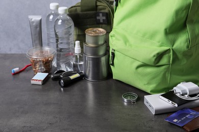 Photo of Survival kit. Different emergency supplies on grey table