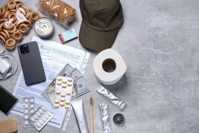 Photo of Survival kit. Different emergency supplies on grey table, flat lay. Space for text