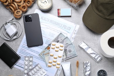Photo of Survival kit. Different emergency supplies on grey table, flat lay