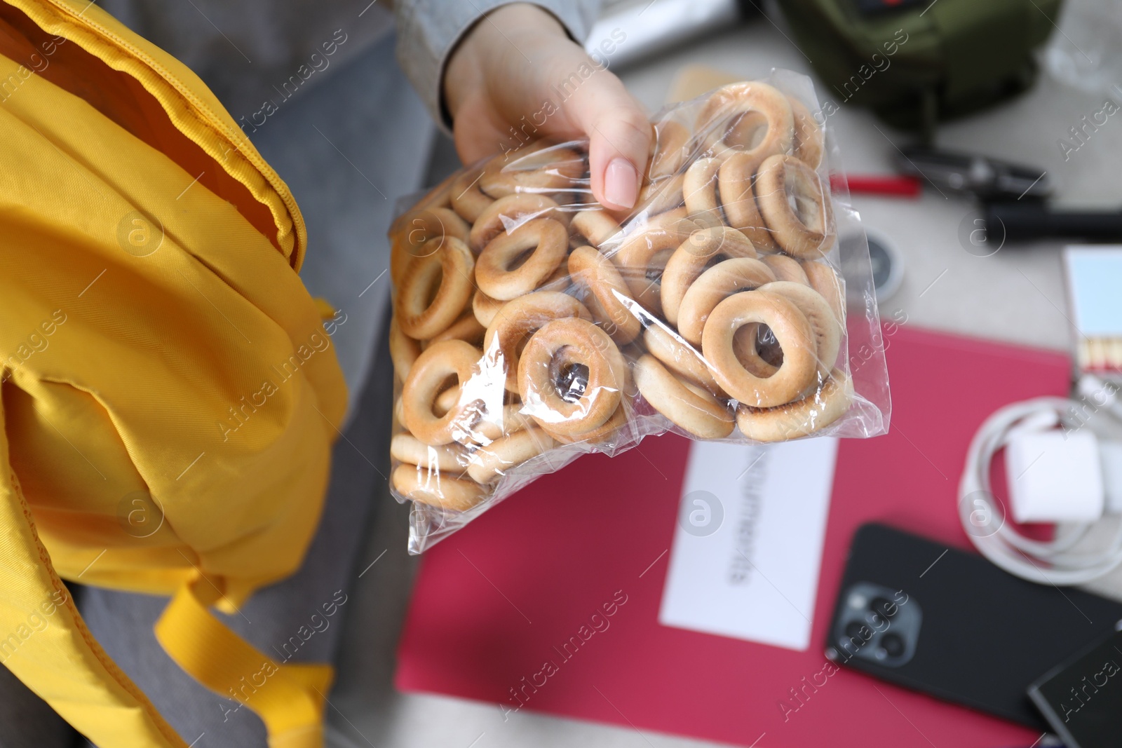Survival kit. Woman packing different emergency supplies on sofa indoors, closeup Photo of Survival kit. Woman packing different emergency supplies on sofa indoors, closeup