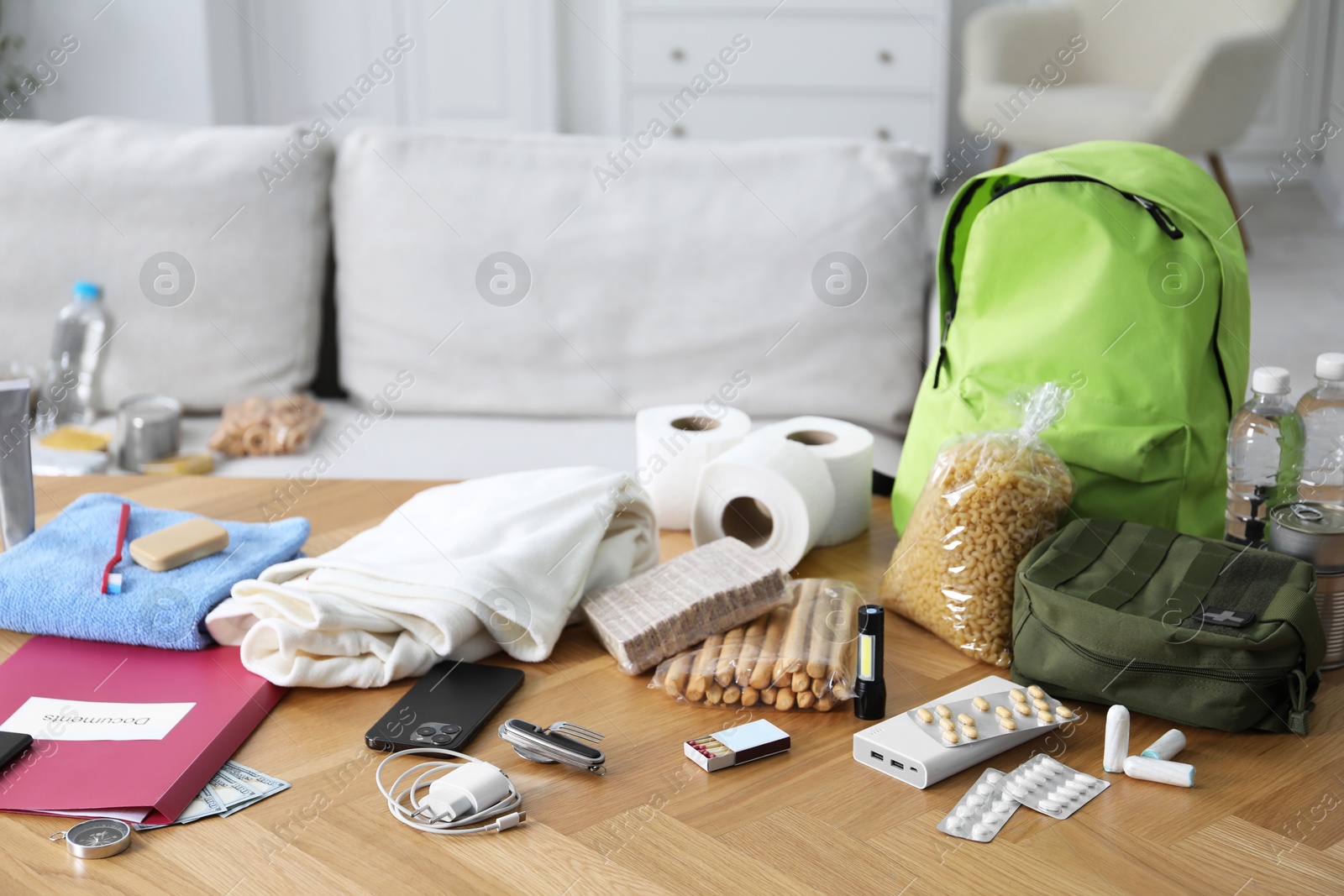 Survival kit. Different emergency supplies on wooden table indoors Photo of Survival kit. Different emergency supplies on wooden table indoors