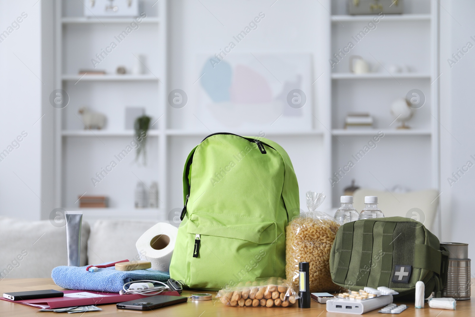 Survival kit. Different emergency supplies on wooden table indoors Photo of Survival kit. Different emergency supplies on wooden table indoors