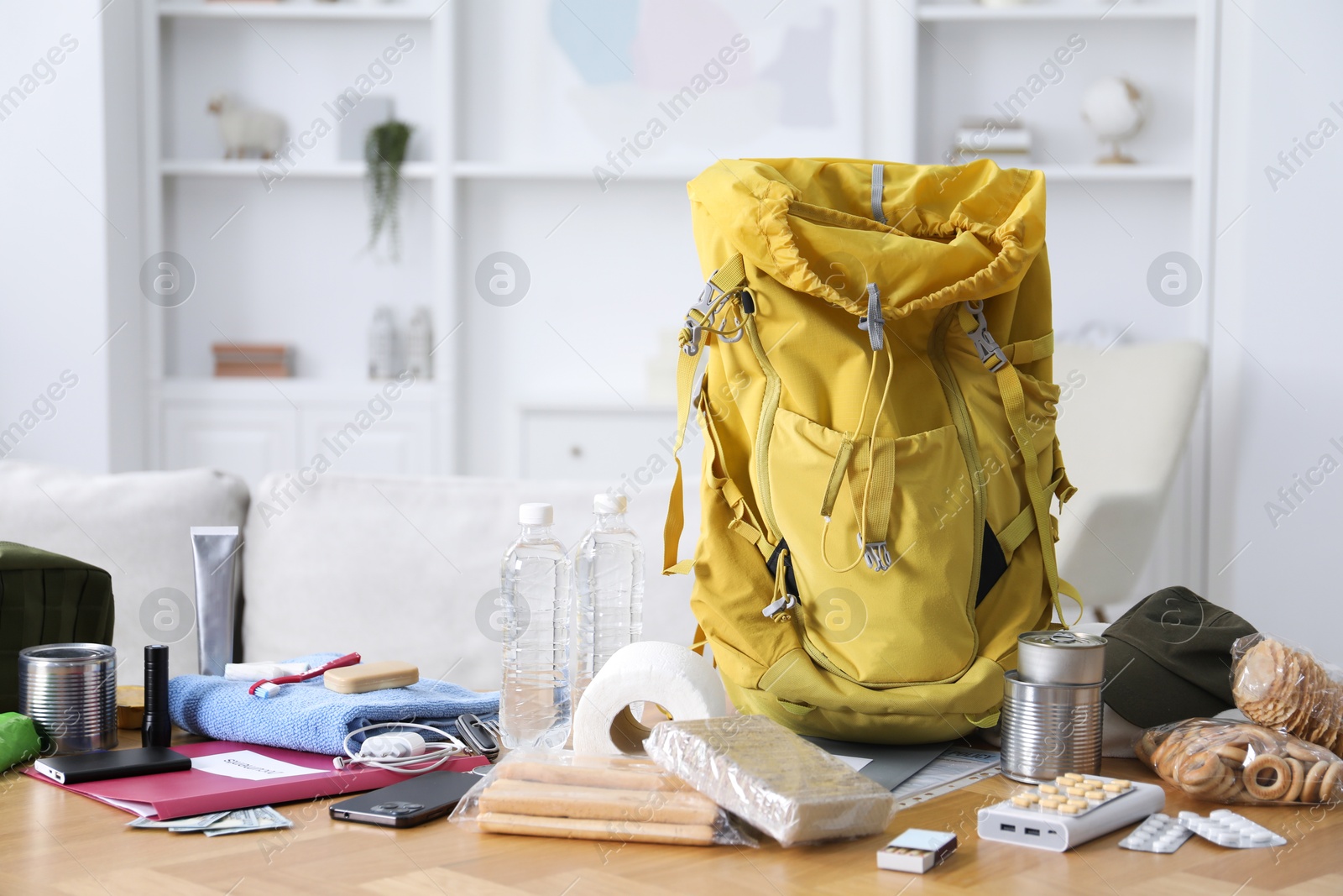Survival kit. Different emergency supplies on wooden table indoors Photo of Survival kit. Different emergency supplies on wooden table indoors