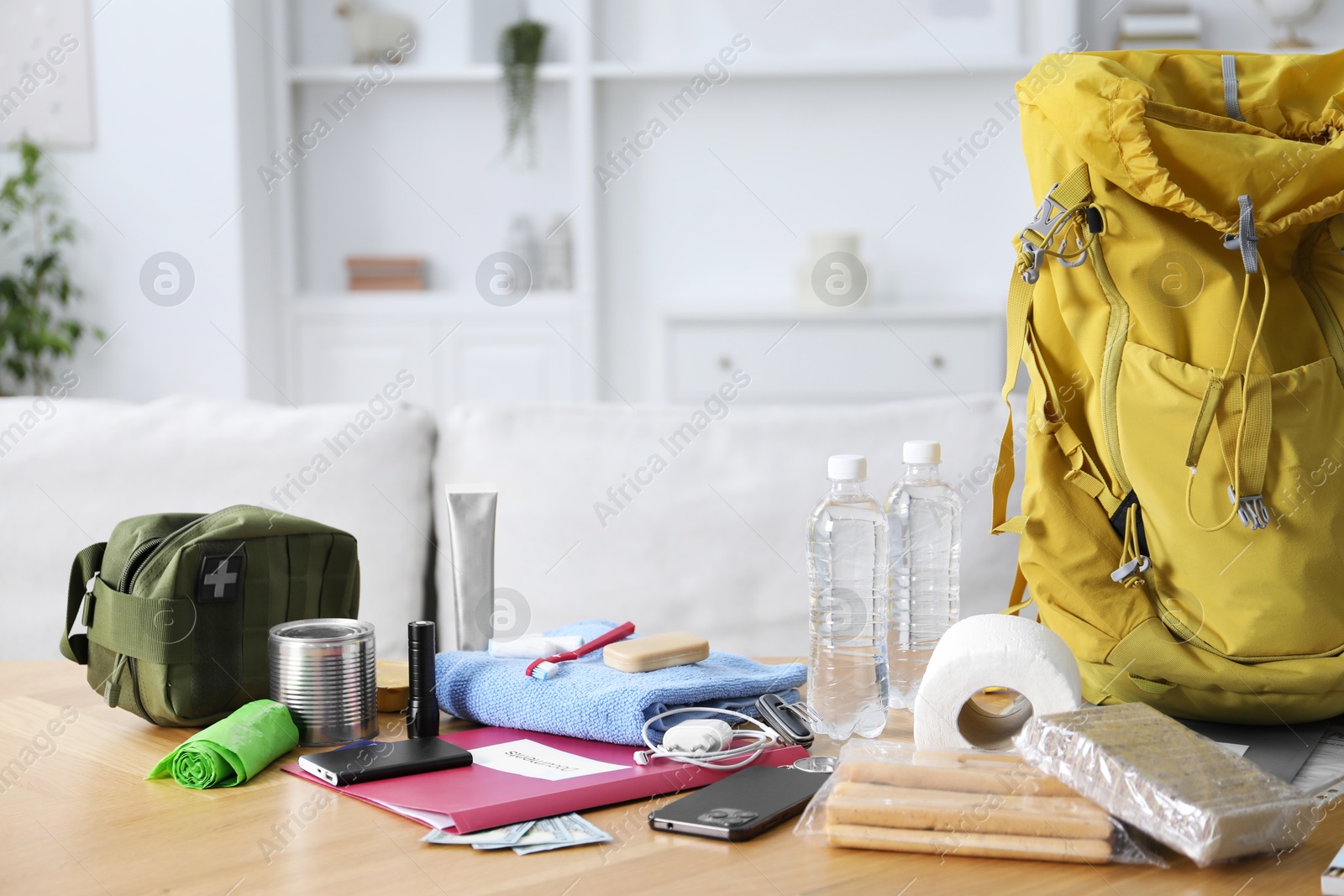 Survival kit. Different emergency supplies on wooden table indoors Photo of Survival kit. Different emergency supplies on wooden table indoors