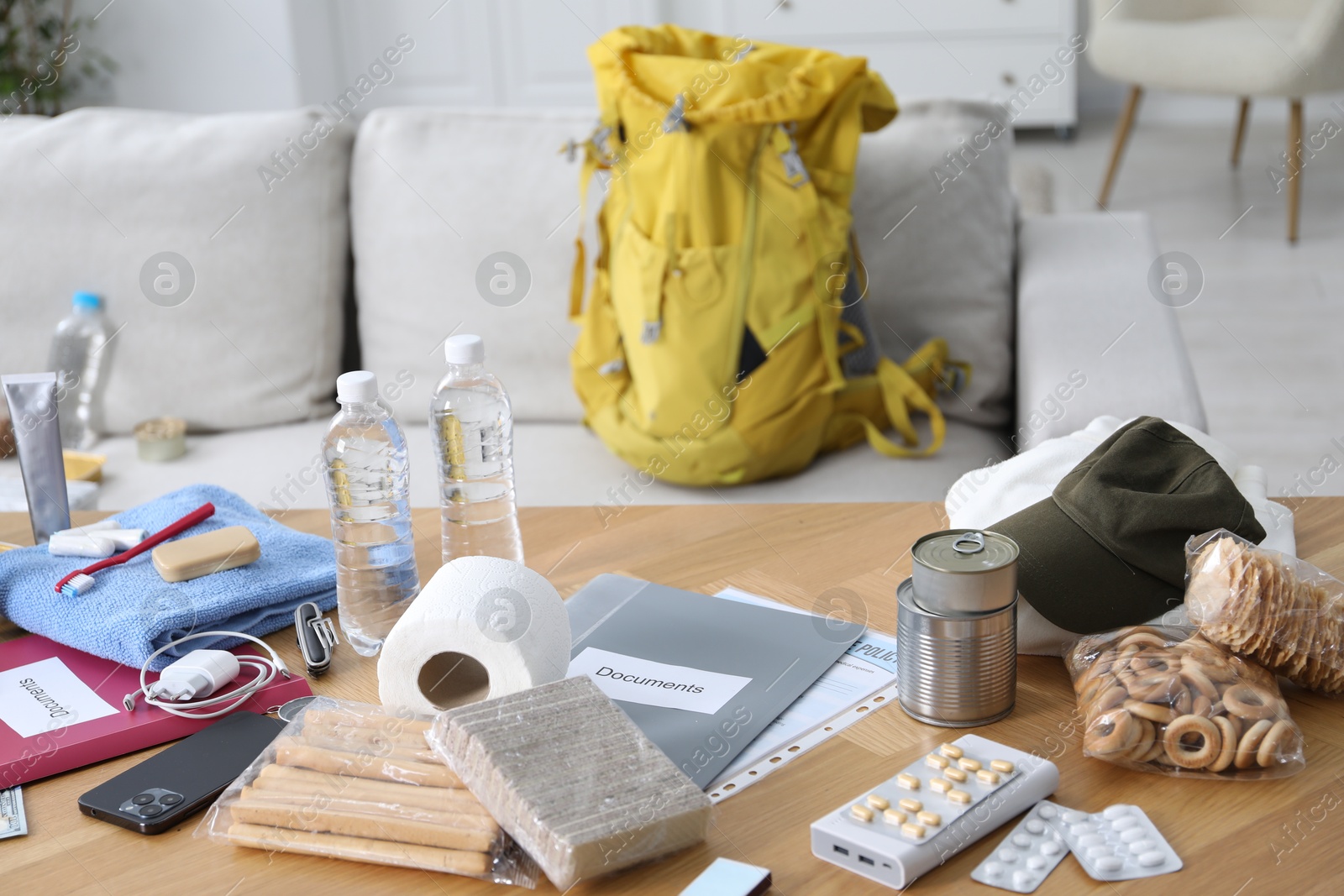Survival kit. Different emergency supplies on wooden table indoors Photo of Survival kit. Different emergency supplies on wooden table indoors