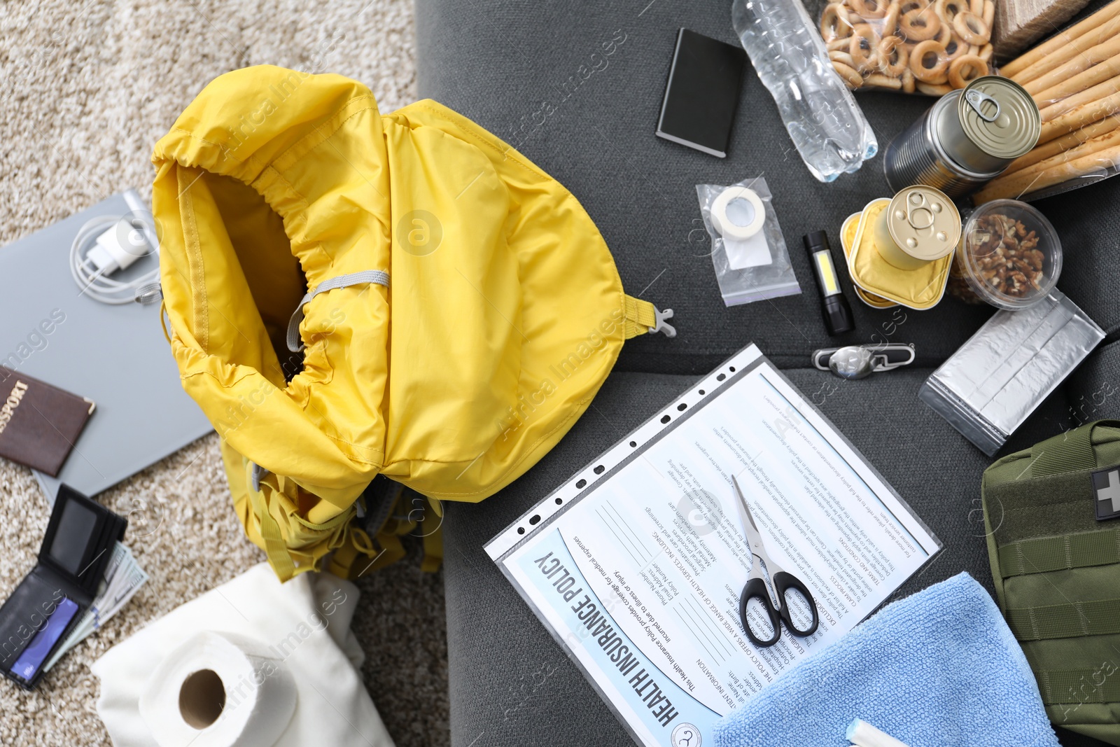 Survival kit. Different emergency supplies at home, top view Photo of Survival kit. Different emergency supplies at home, top view