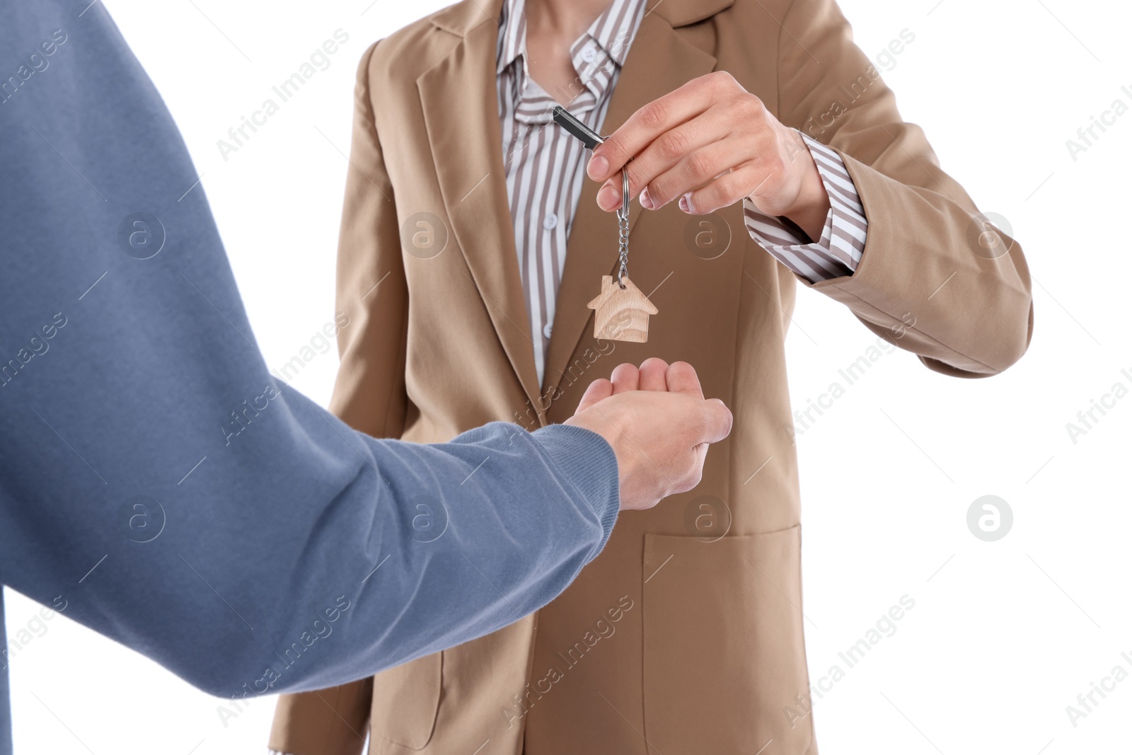 Real estate agent giving house key to new owner on white background, closeup Photo of Real estate agent giving house key to new owner on white background, closeup