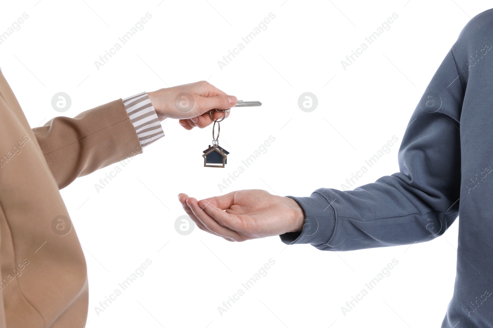 Real estate agent giving house key to new owner on white background, closeup Photo of Real estate agent giving house key to new owner on white background, closeup