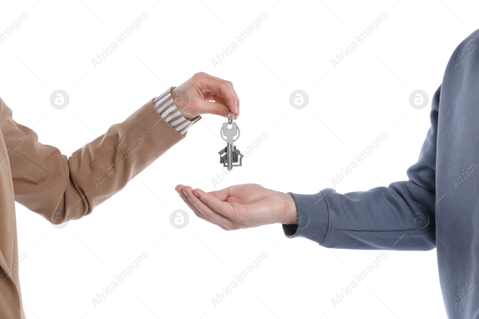 Real estate agent giving house key to new owner on white background, closeup Photo of Real estate agent giving house key to new owner on white background, closeup