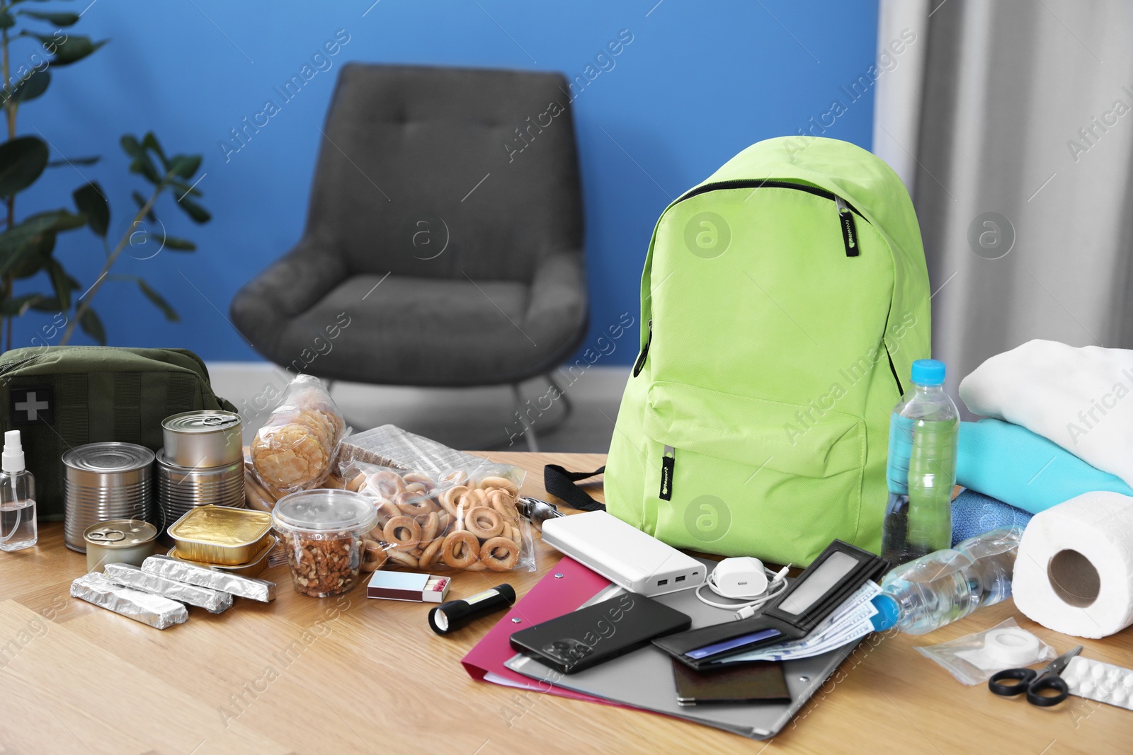 Survival kit. Different emergency supplies on wooden table indoors Photo of Survival kit. Different emergency supplies on wooden table indoors
