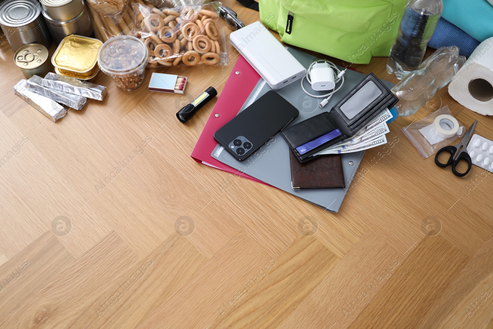 Survival kit. Different emergency supplies on wooden table indoors, above view Photo of Survival kit. Different emergency supplies on wooden table indoors, above view