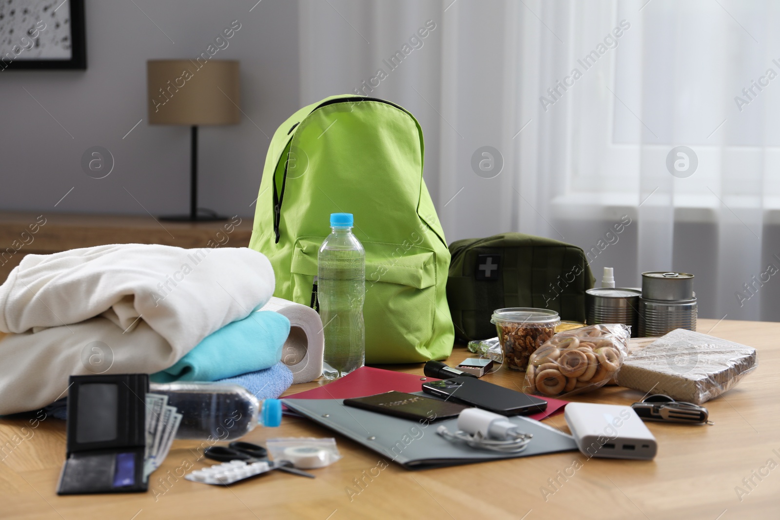Survival kit. Different emergency supplies on wooden table indoors Photo of Survival kit. Different emergency supplies on wooden table indoors