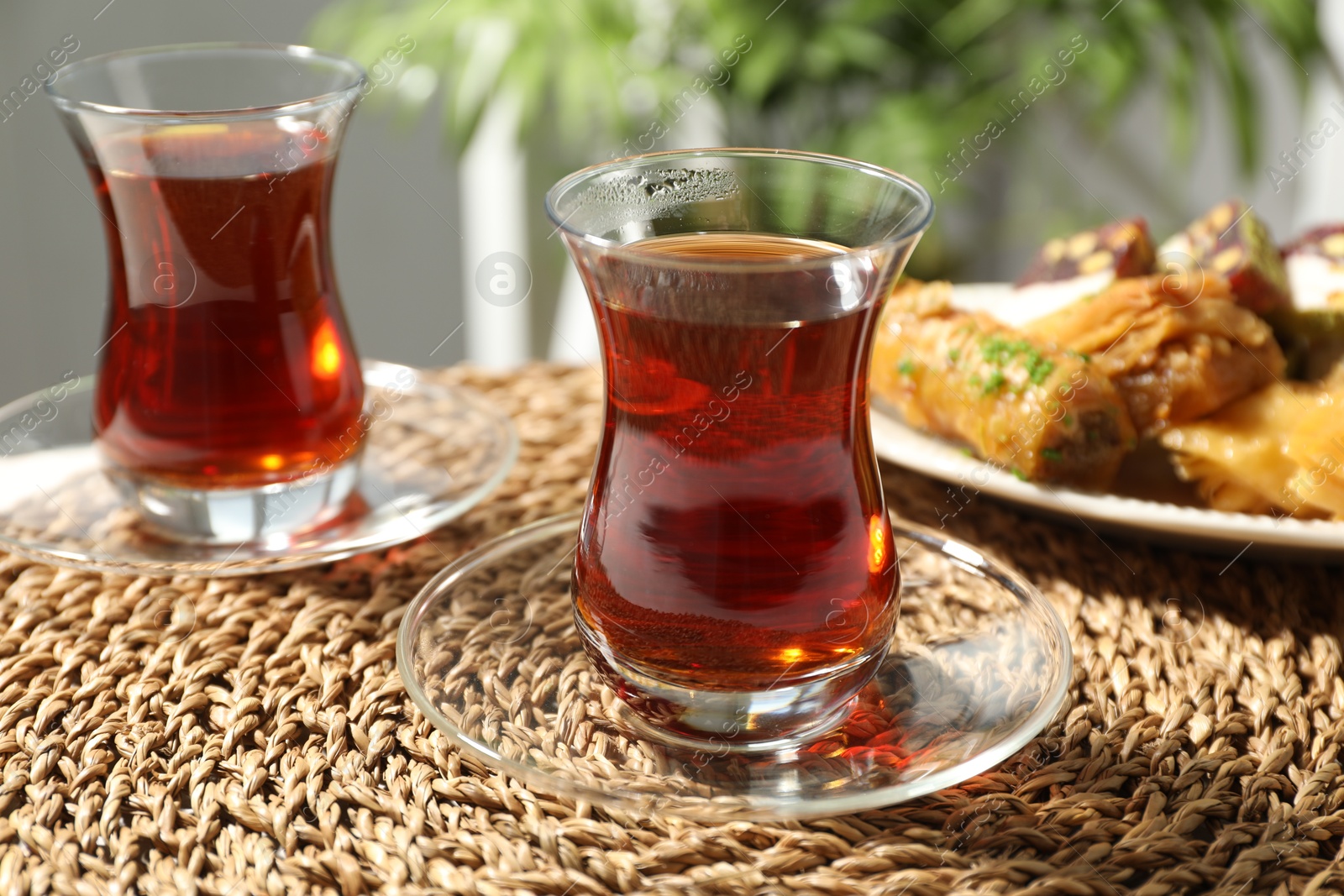 Traditional Turkish tea in glass cups and sweets on table, closeup Photo of Traditional Turkish tea in glass cups and sweets on table, closeup