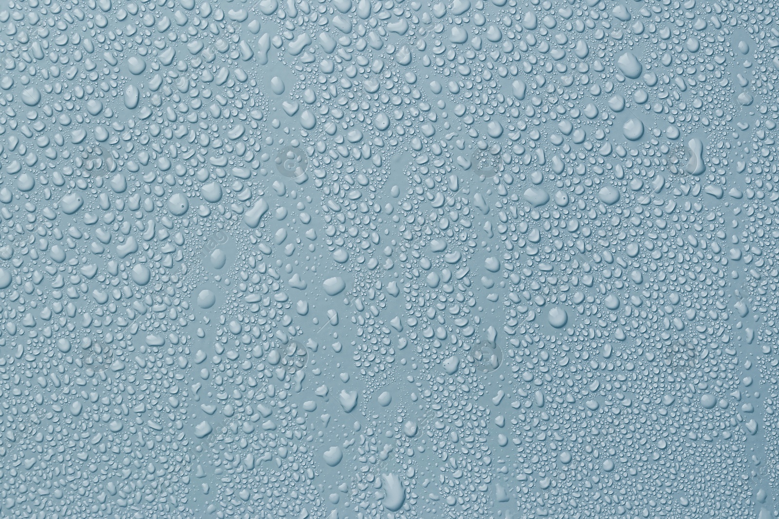 Many water drops on light blue background Image of Many water drops on light blue background