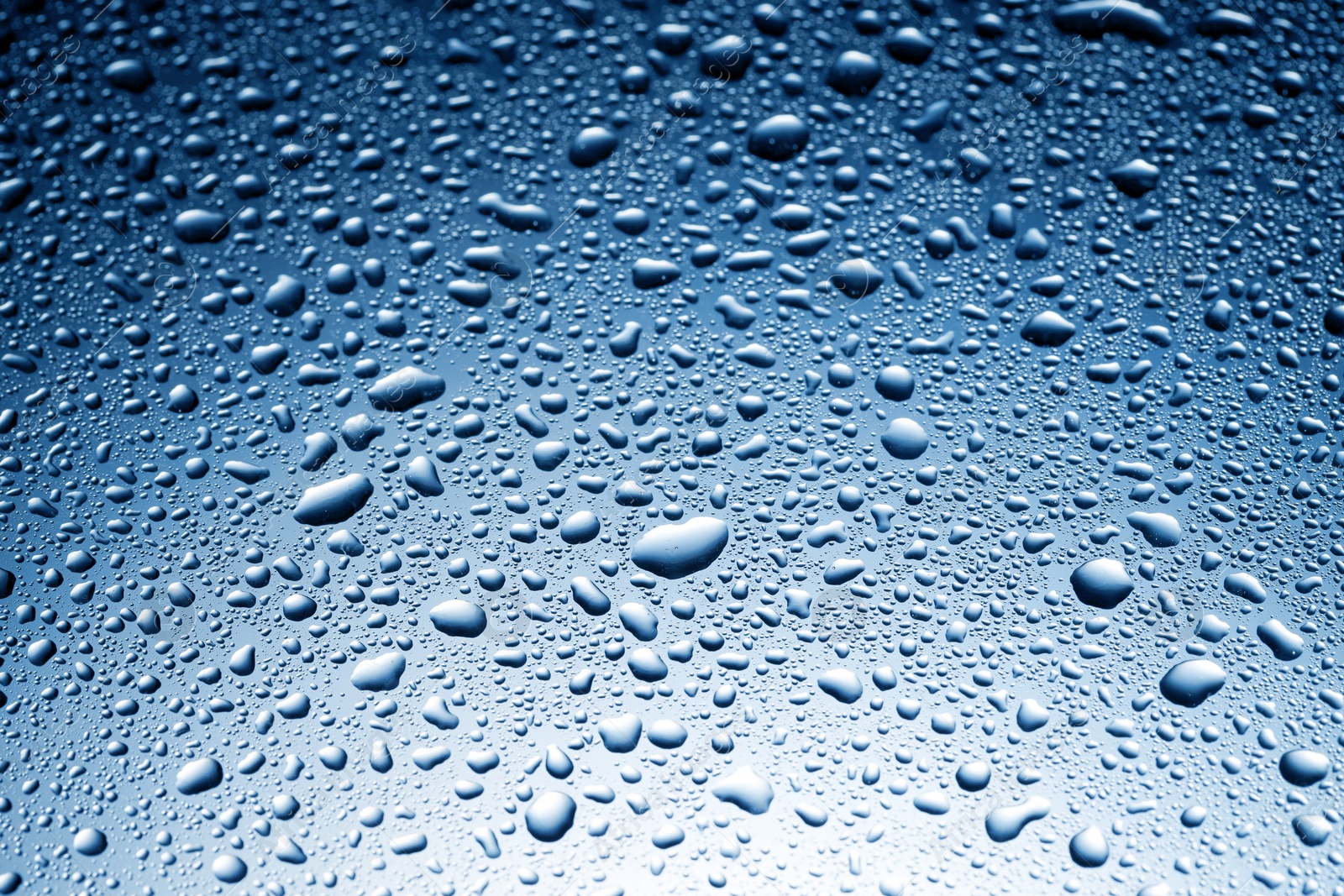 Many water drops on glass surface, closeup Image of Many water drops on glass surface, closeup