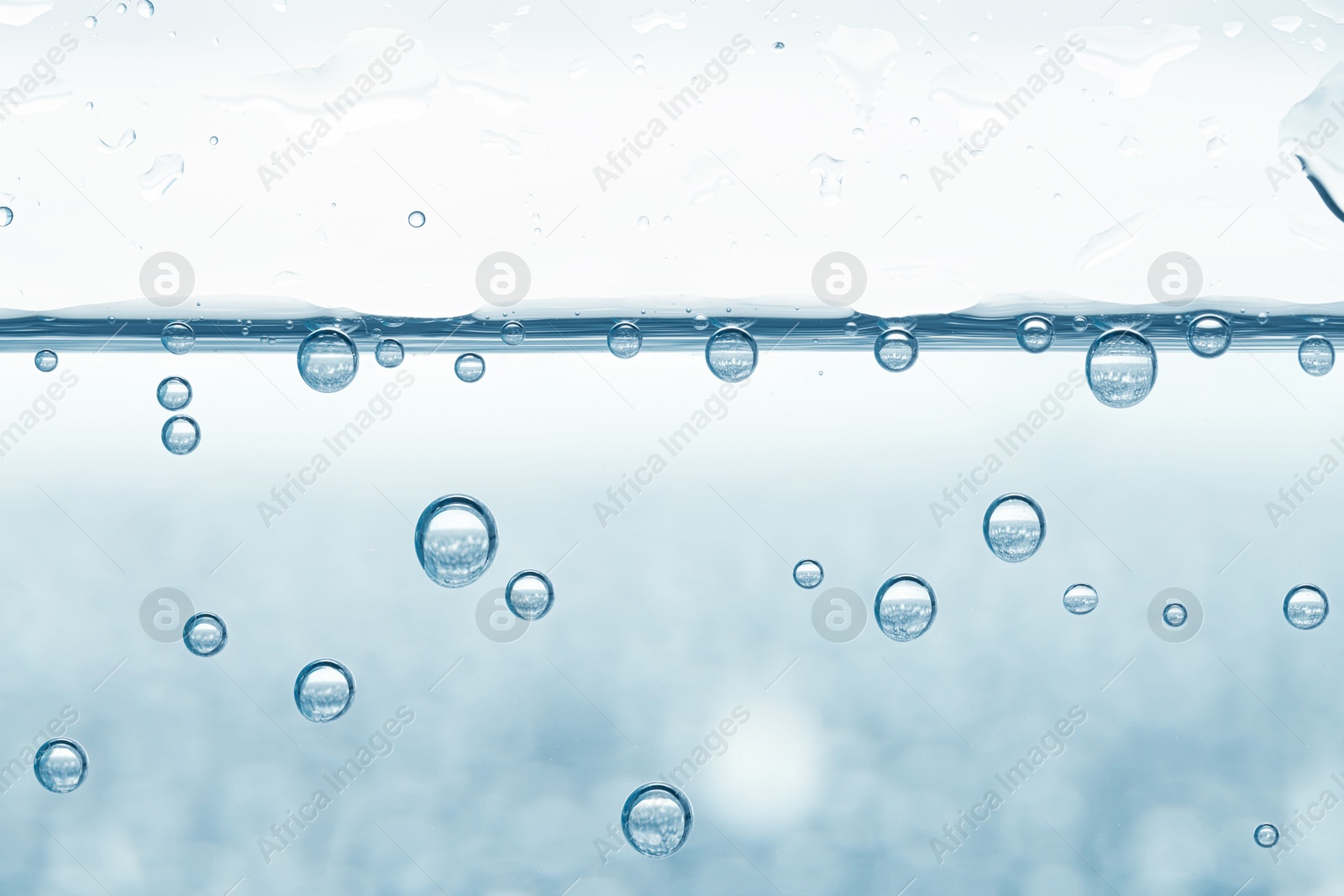 Soda water with bubbles in glass, closeup Image of Soda water with bubbles in glass, closeup
