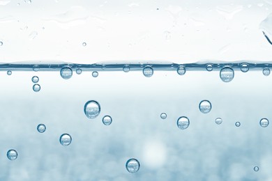 Image of Soda water with bubbles in glass, closeup