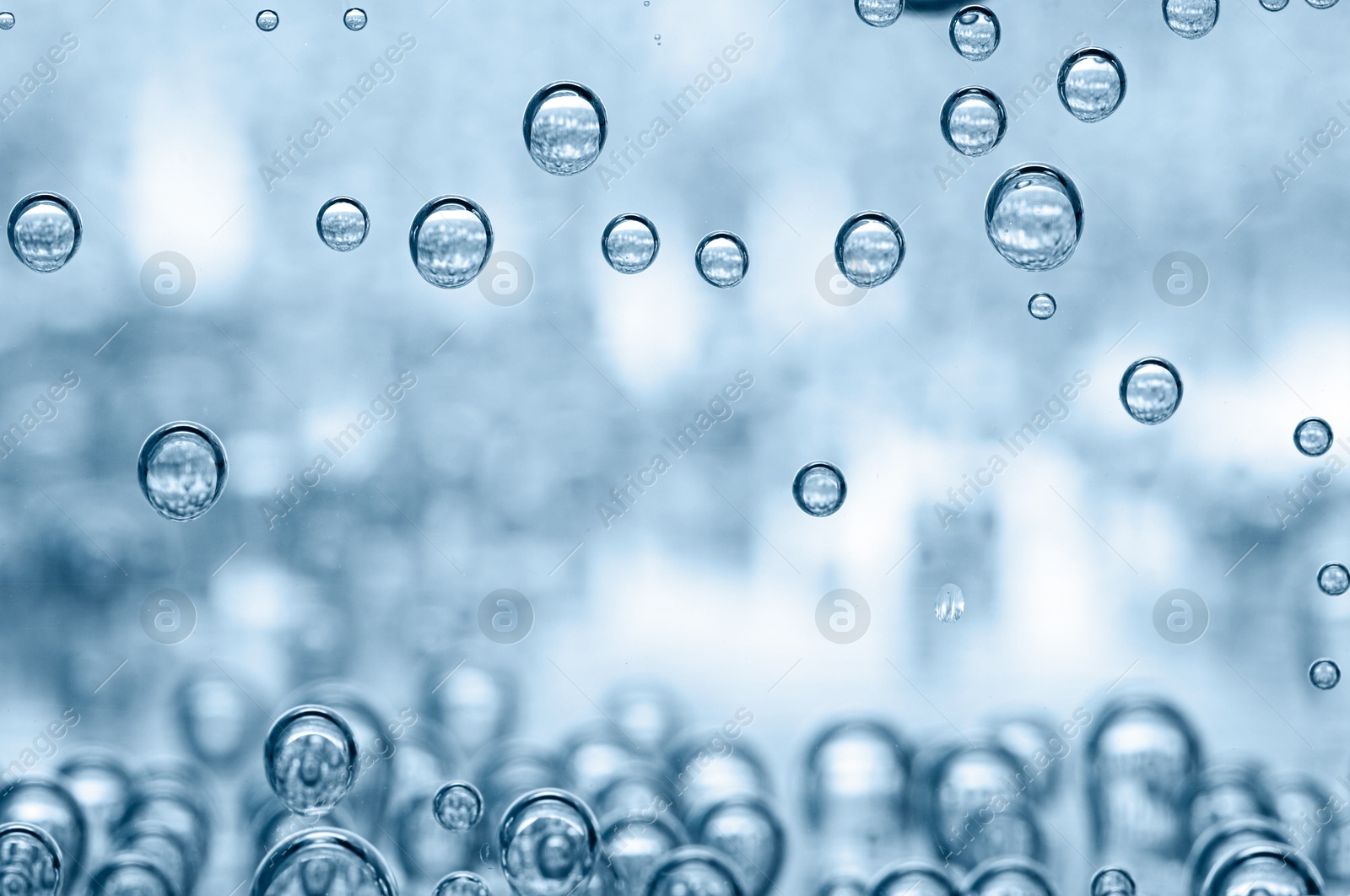 Soda water with bubbles in glass, closeup Image of Soda water with bubbles in glass, closeup