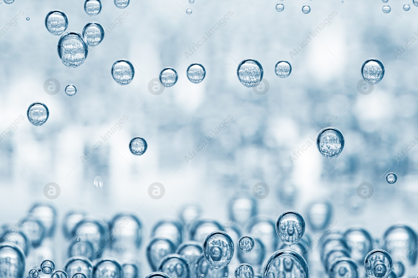 Soda water with bubbles in glass, closeup Image of Soda water with bubbles in glass, closeup