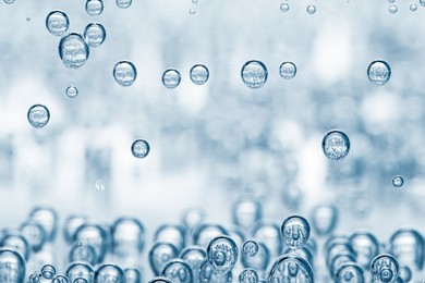 Image of Soda water with bubbles in glass, closeup