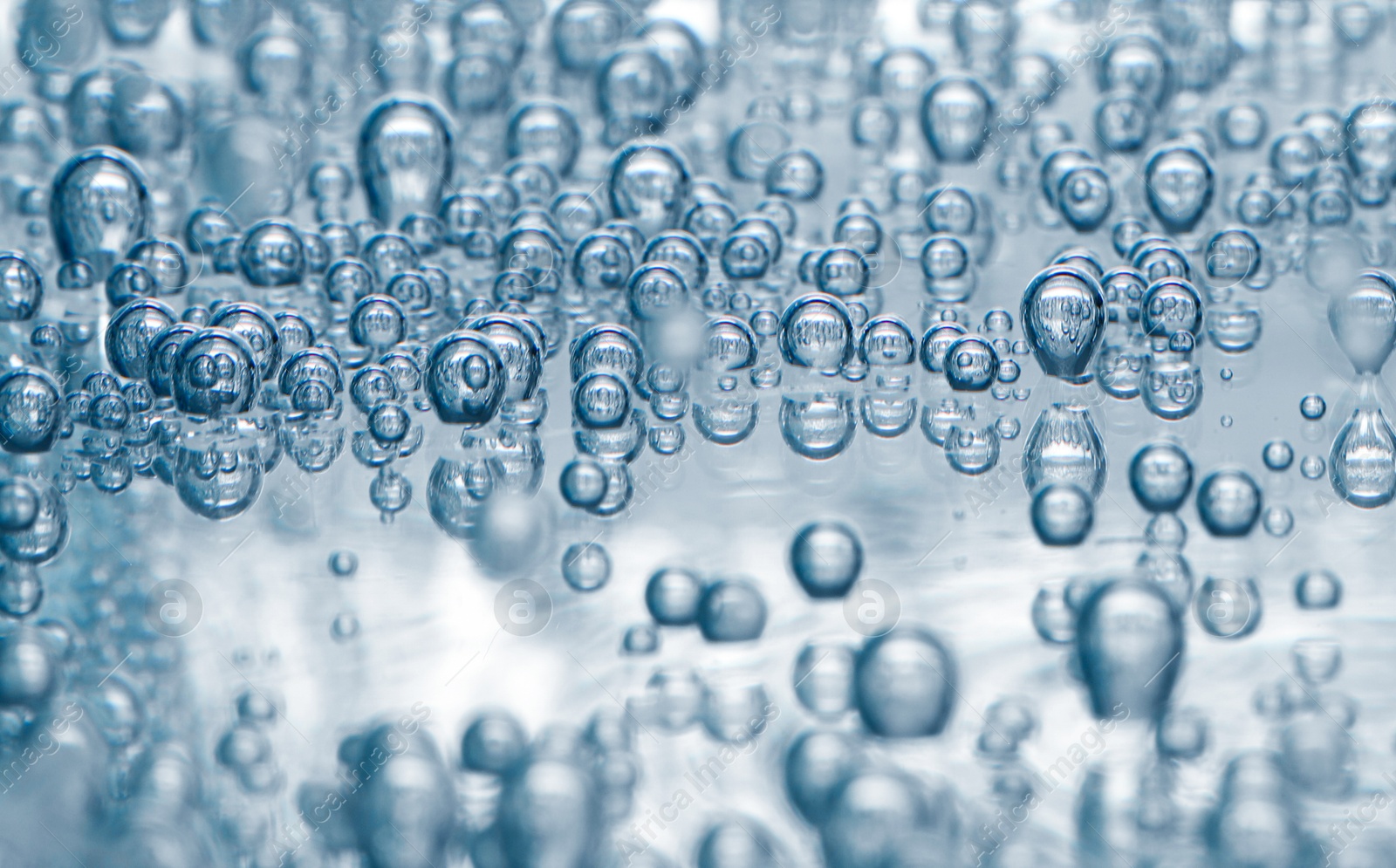 Soda water with bubbles in glass, closeup Image of Soda water with bubbles in glass, closeup