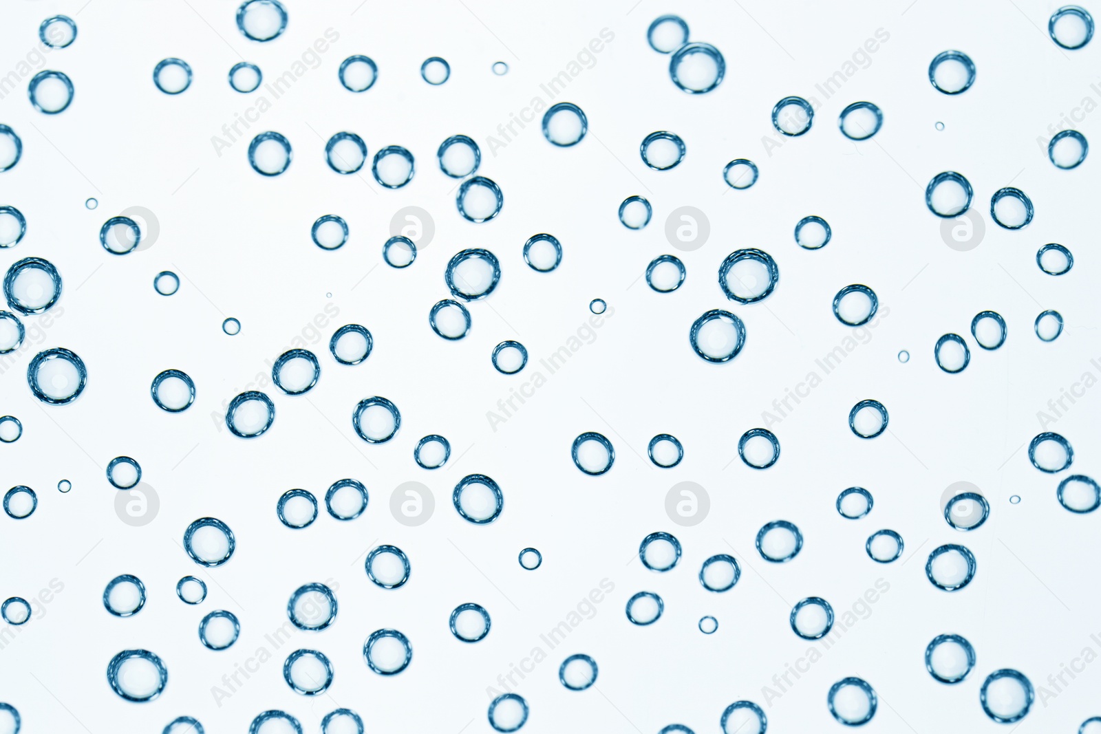 Soda water with bubbles as background, closeup Image of Soda water with bubbles as background, closeup