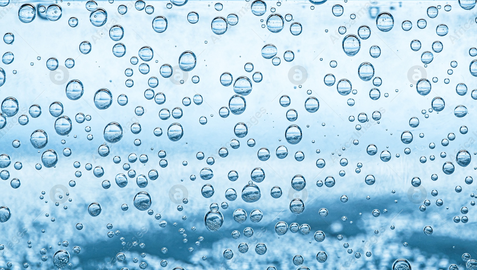Soda water with bubbles as background, closeup Image of Soda water with bubbles as background, closeup