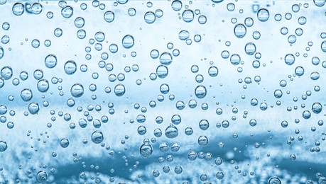 Image of Soda water with bubbles as background, closeup