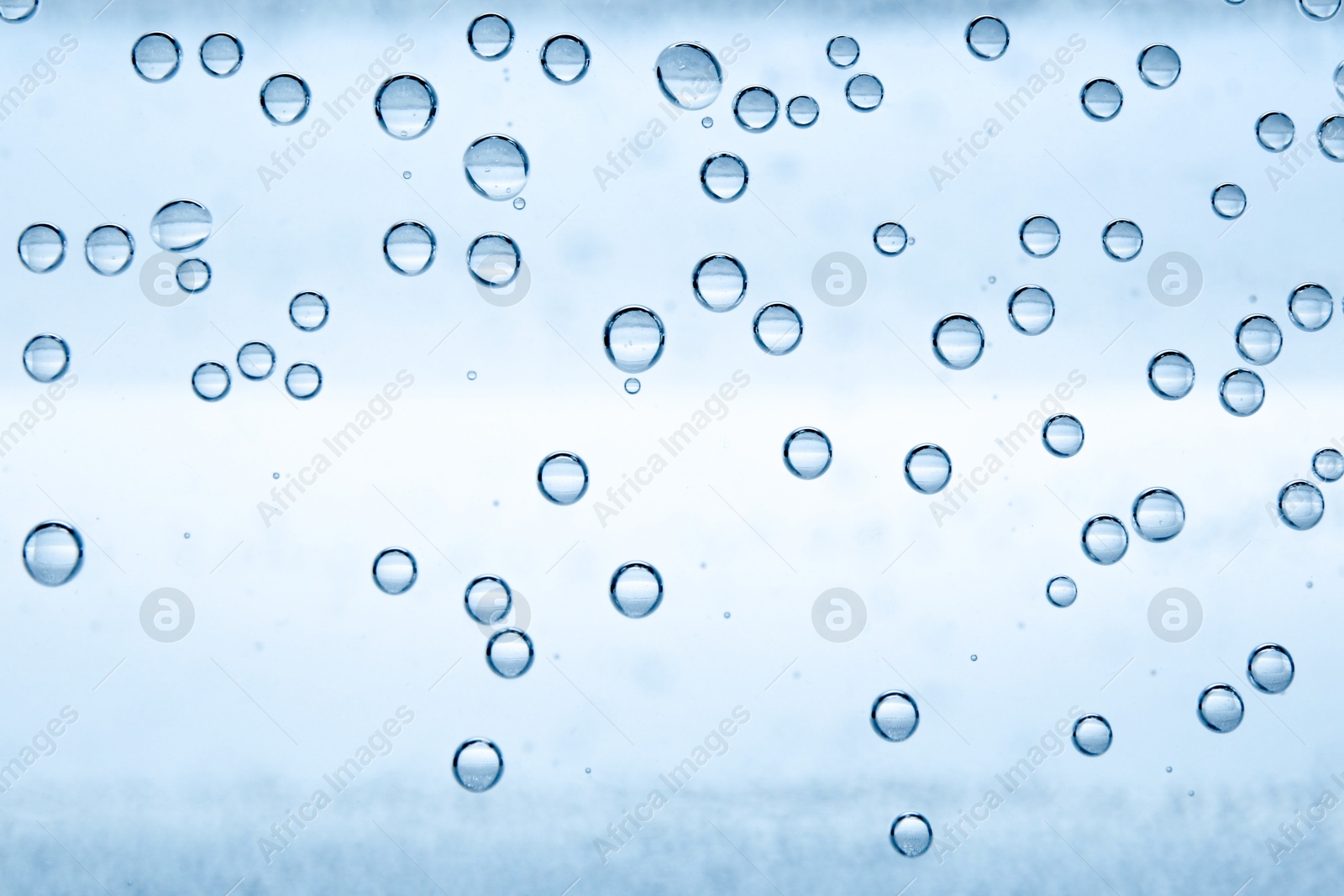 Soda water with bubbles as background, closeup Image of Soda water with bubbles as background, closeup