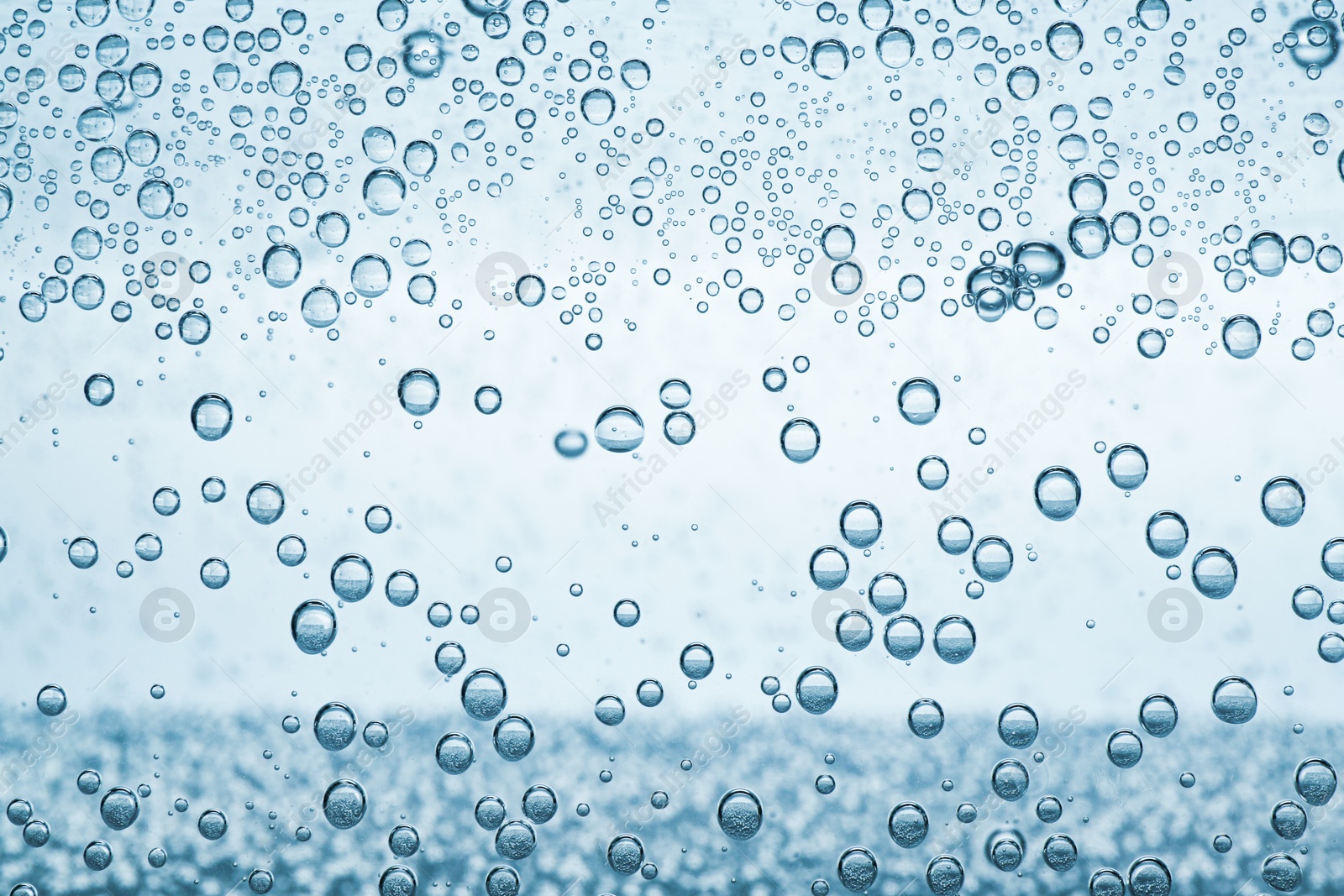 Soda water with bubbles as background, closeup Image of Soda water with bubbles as background, closeup