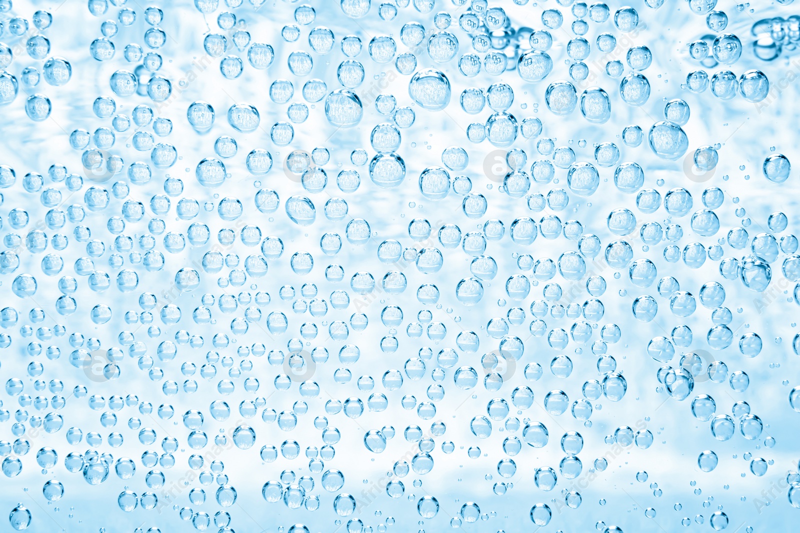 Soda water with bubbles as background, closeup Image of Soda water with bubbles as background, closeup