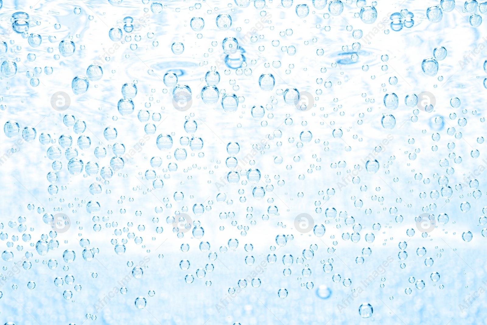 Soda water with bubbles as background, closeup Image of Soda water with bubbles as background, closeup
