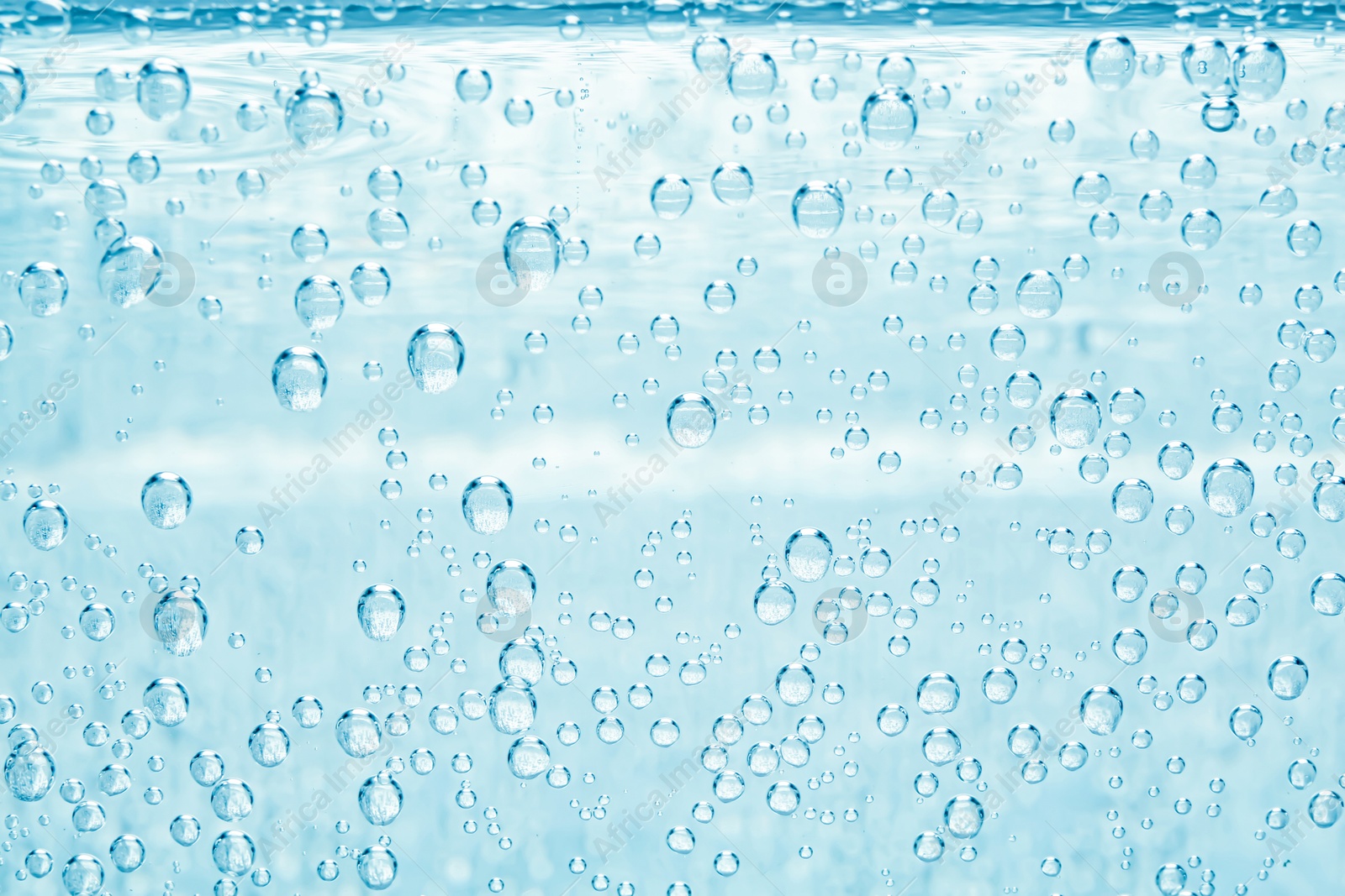 Soda water with bubbles as background, closeup Image of Soda water with bubbles as background, closeup