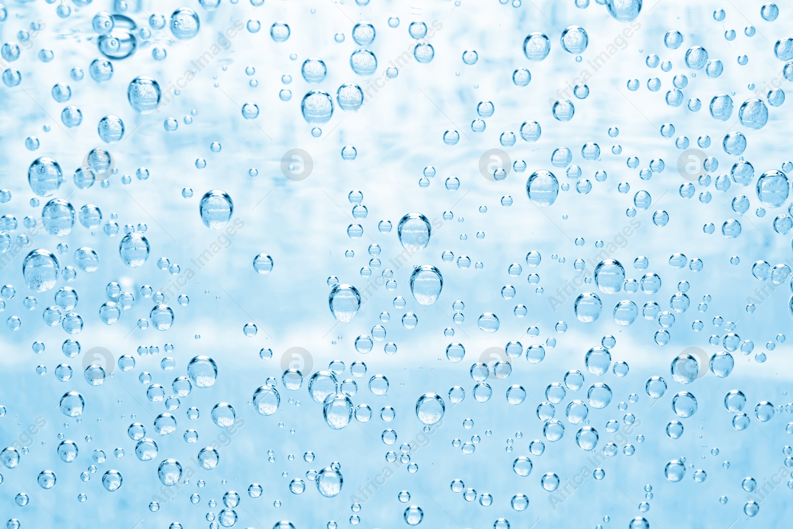 Soda water with bubbles as background, closeup Image of Soda water with bubbles as background, closeup