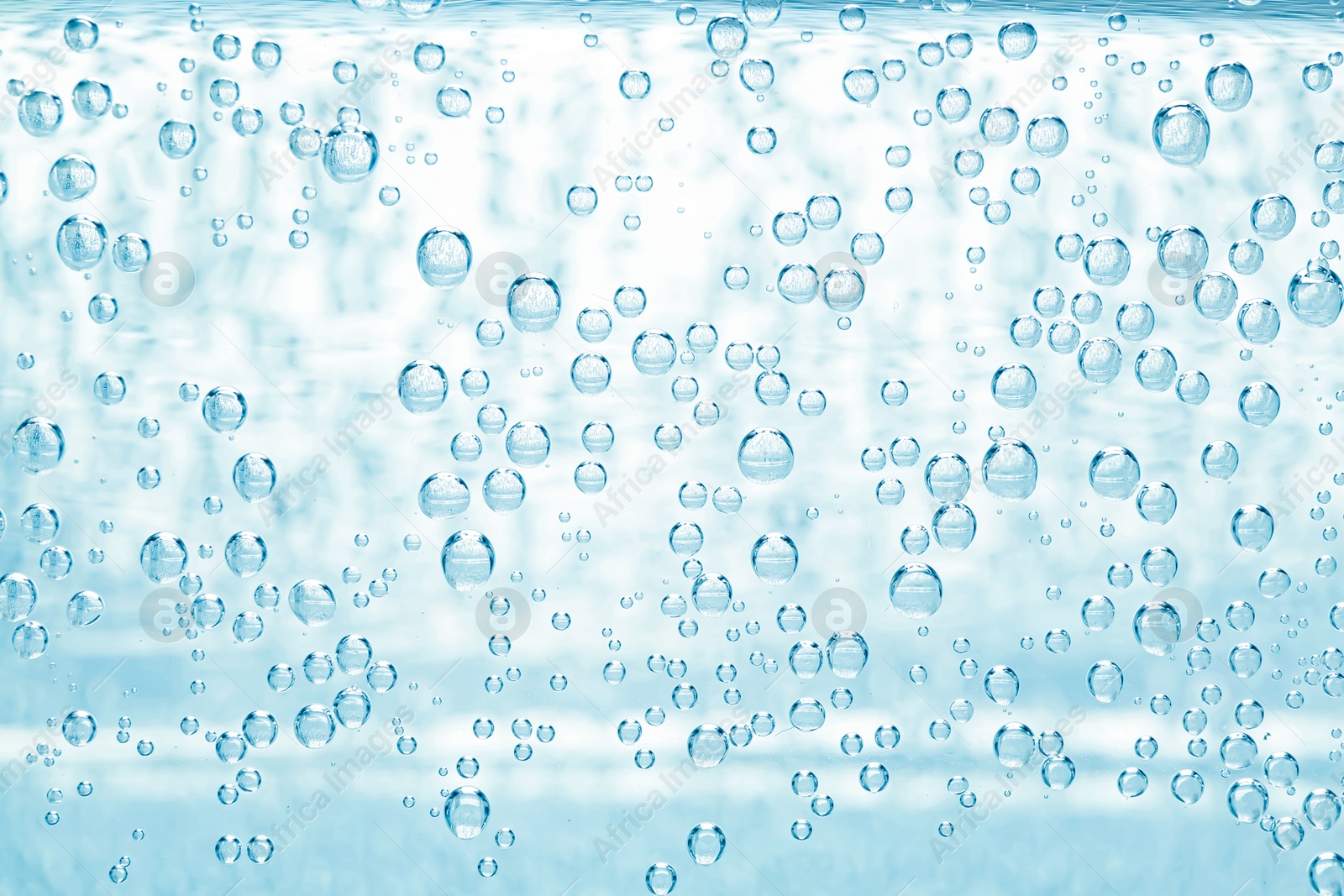Soda water with bubbles as background, closeup Image of Soda water with bubbles as background, closeup